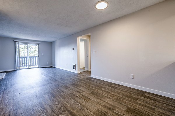 Spacious living room with contemporary furnishings at 1202 Pearl Apartments