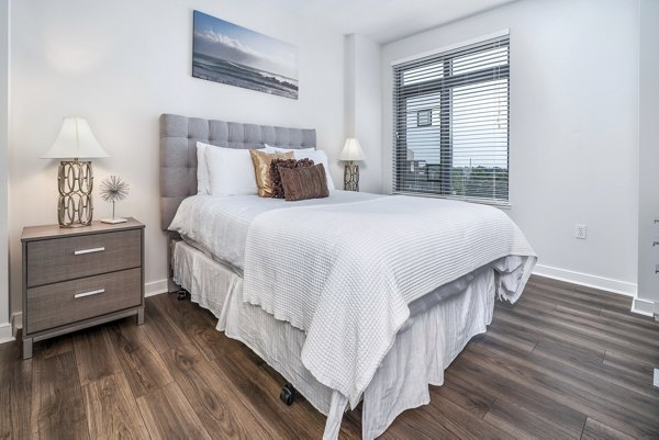 Cozy bedroom with modern decor at The Barton at Woodley Apartments