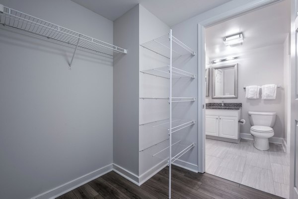 Bathroom with modern fixtures and walk-in closet at The Barton at Woodley Apartments