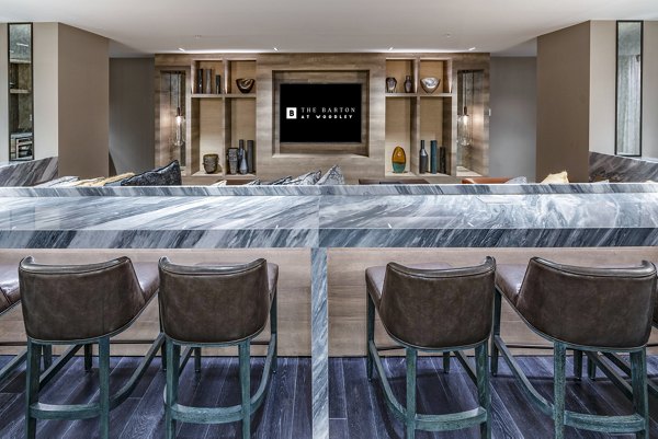 Clubhouse with cozy seating and modern design at The Barton at Woodley Apartments