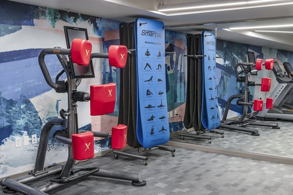 Modern fitness center with state-of-the-art equipment at The Barton at Woodley Apartments, ideal for active lifestyles