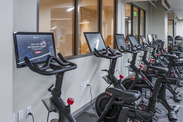 State-of-the-art fitness center featuring modern equipment at The Barton at Woodley Apartments