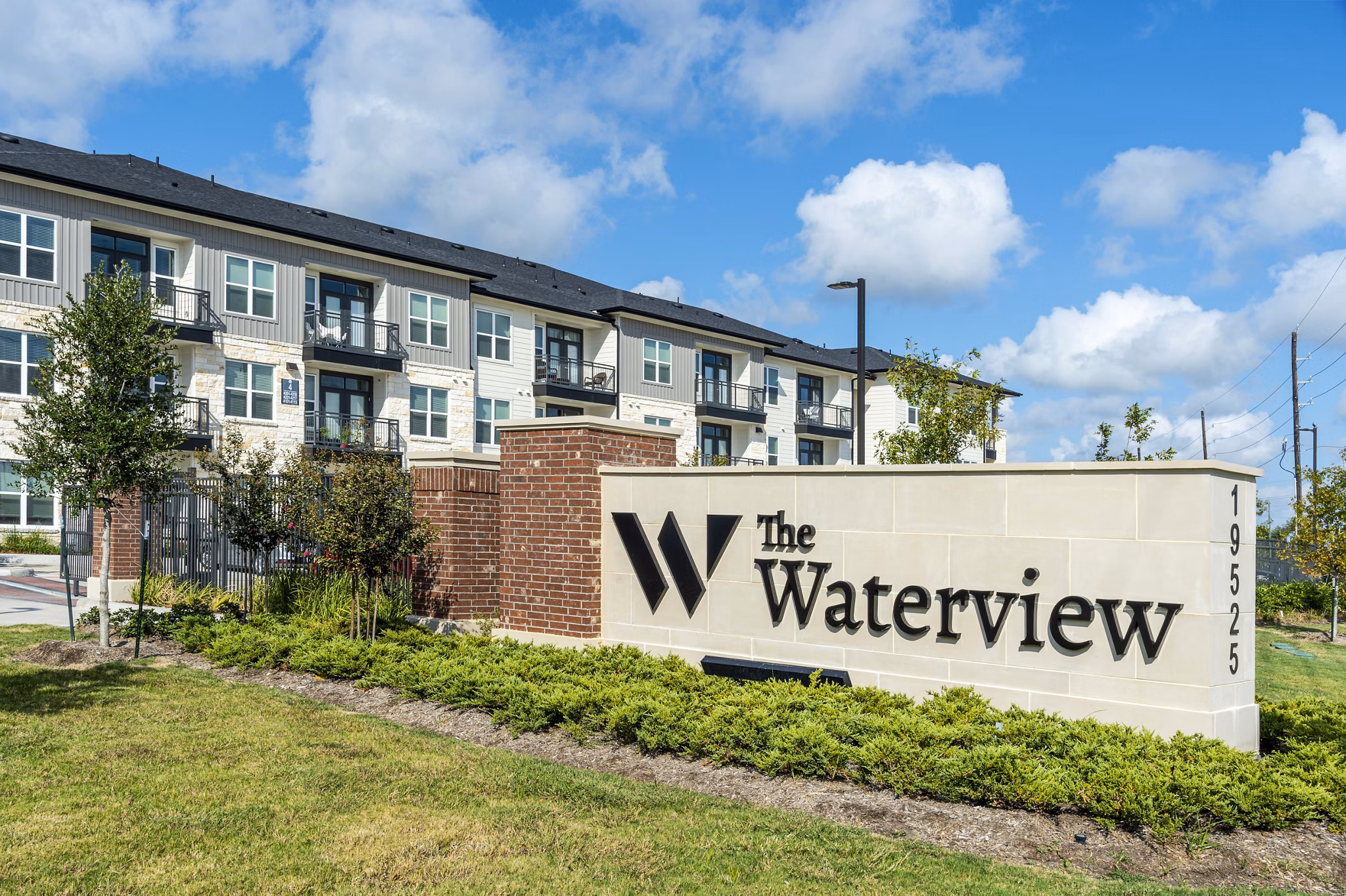 The Waterview Apartments: Stylish signage at luxury property featuring waterfront views