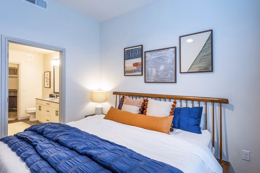 Bright bedroom with waterfront views at The Waterview Apartments, featuring stylish decor and natural light
