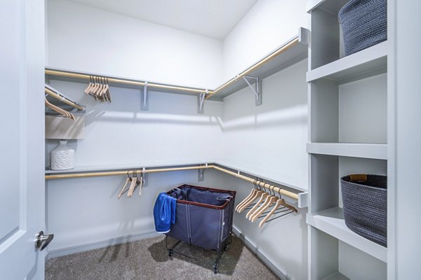 Bedroom closet with built-in shelving and ample storage space at The Waterview Apartments