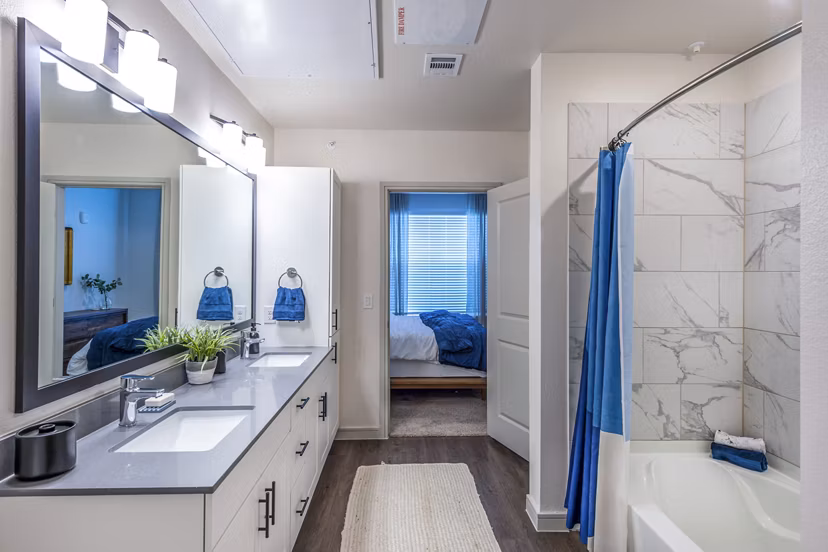 Bathroom featuring modern fixtures and elegant marble countertops at The Waterview Apartments