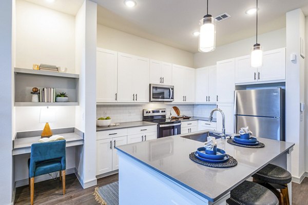 Modern kitchen with stainless steel appliances at The Waterview Apartments
