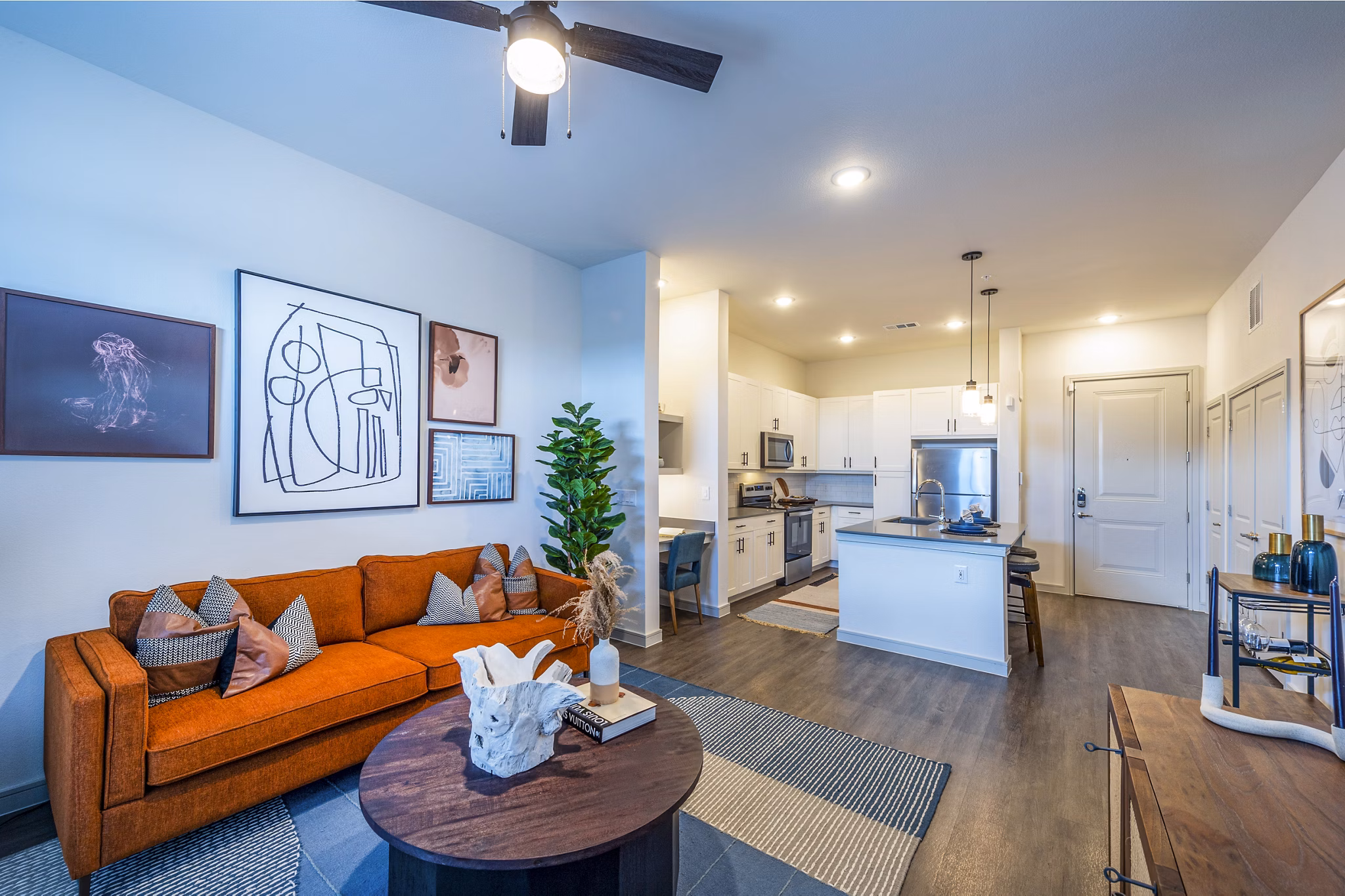 Contemporary living room with elegant decor and city views at The Waterview Apartments
