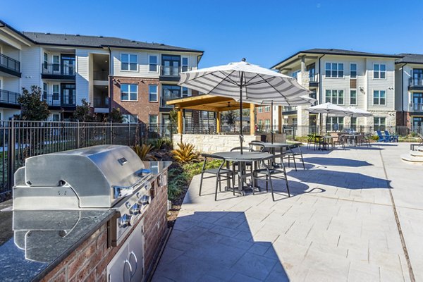 Grill area with modern patio seating at The Waterview Apartments, a Greystar luxury community
