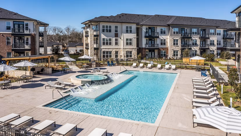 Resort-style pool with lounge chairs at The Waterview Apartments