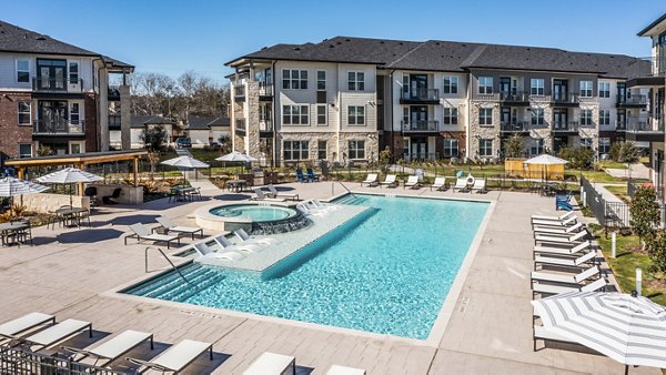 Resort-style pool with lounge chairs at The Waterview Apartments