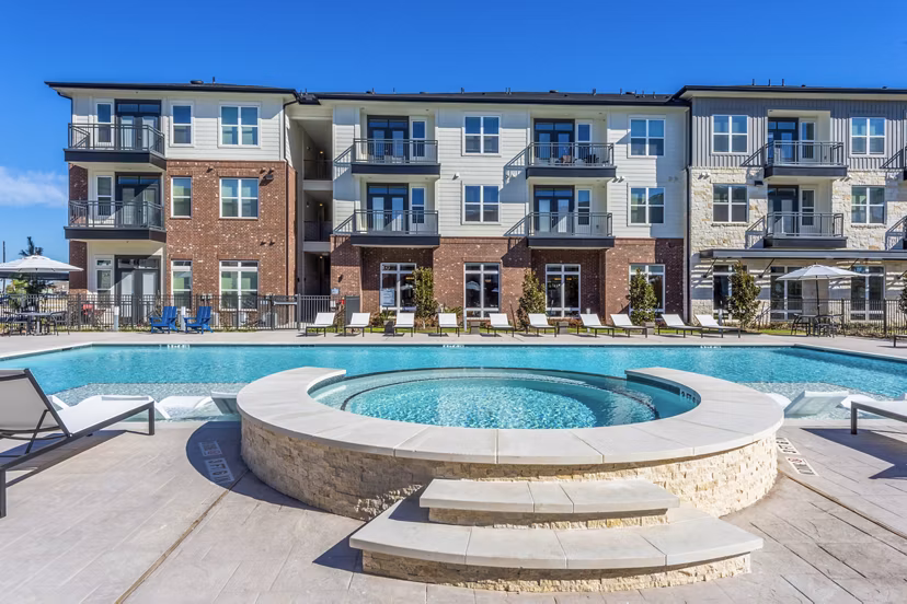 Outdoor pool and hot tub with modern design at The Waterview Apartments, perfect for relaxation and leisure activities