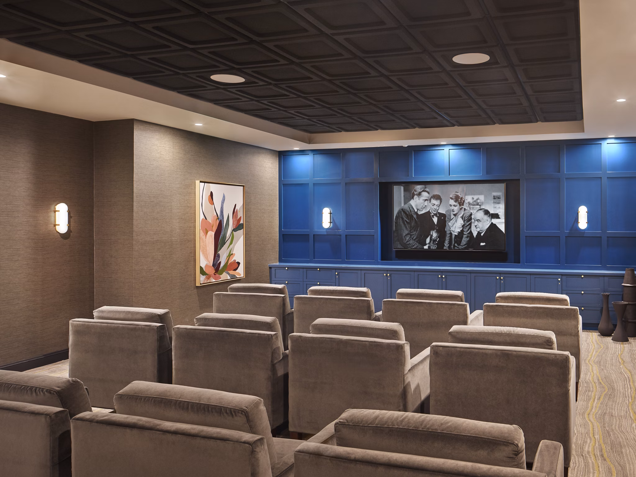 Theater room with plush seating at Icon Riverwalk Apartments, featuring luxury amenities and modern design