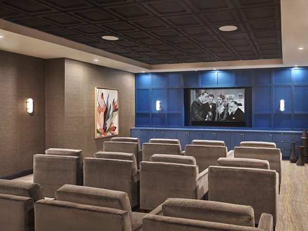 Theater room with plush seating at Icon Riverwalk Apartments, featuring luxury amenities and modern design