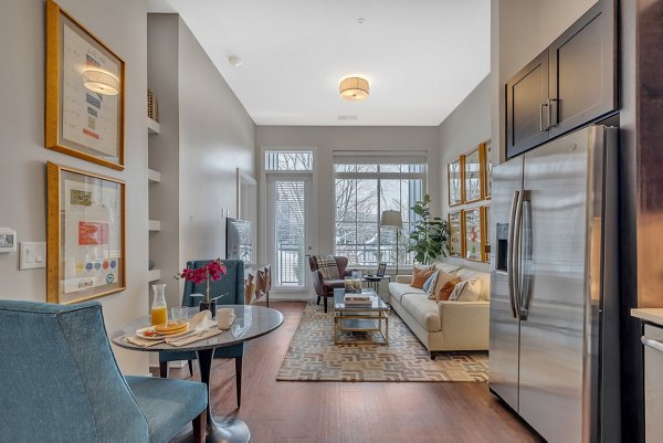 Dining room and kitchen featuring modern appliances and elegant decor at Icon Riverwalk Apartments