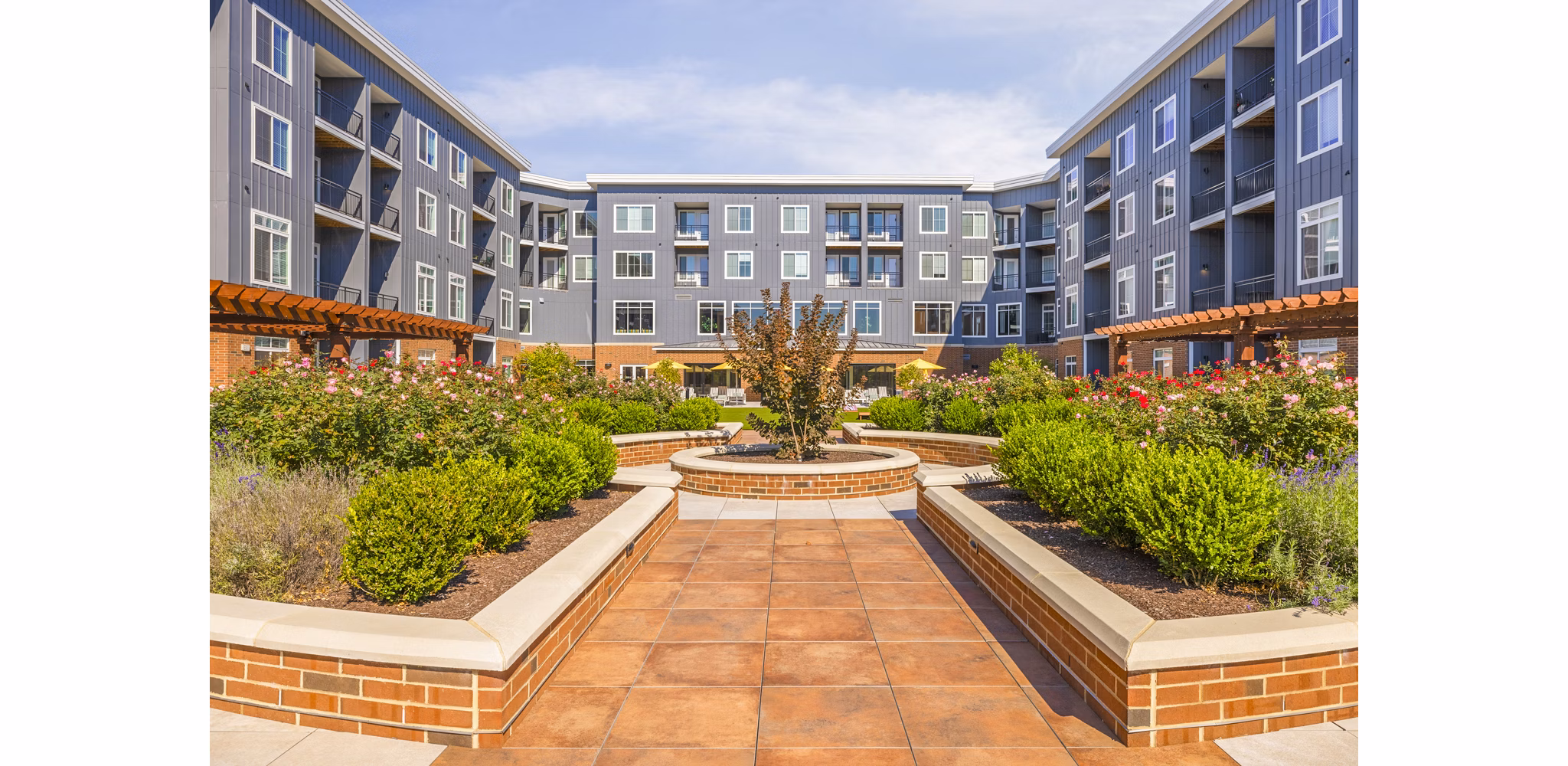 Courtyard patio with lush greenery at Icon Riverwalk Apartments, offering tranquil outdoor space for relaxation