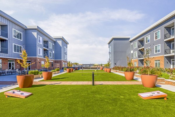 Recreational area with modern seating and game tables at Icon Riverwalk Apartments