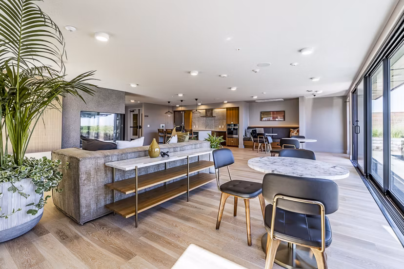 Modern clubhouse featuring cozy seating and ample natural light at Mason & Main Apartments
