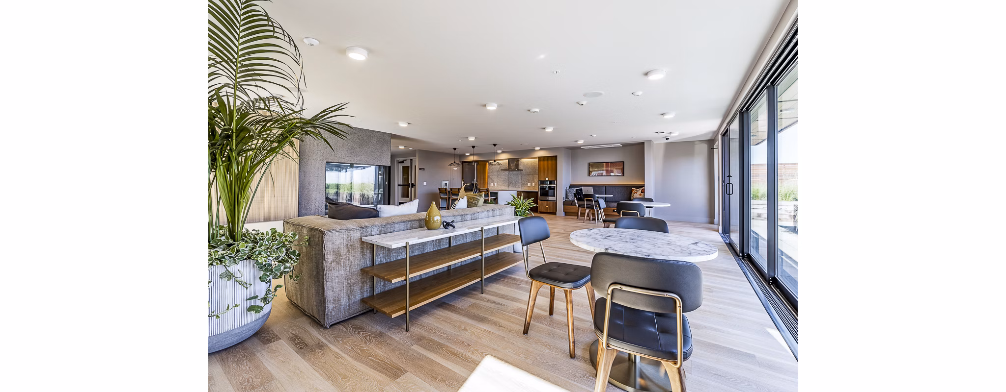 Modern clubhouse featuring cozy seating and ample natural light at Mason & Main Apartments