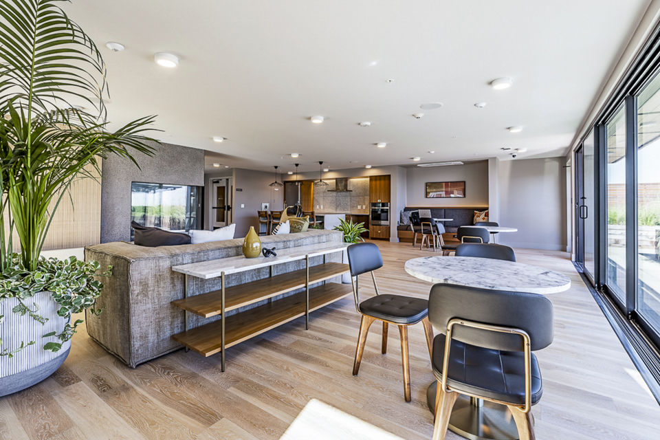 Modern clubhouse featuring cozy seating and ample natural light at Mason & Main Apartments