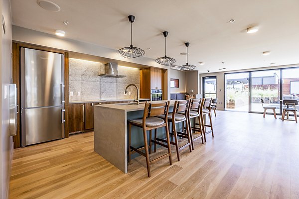 Modern clubhouse at Mason & Main Apartments featuring stylish seating and entertainment areas in a luxury Greystar community