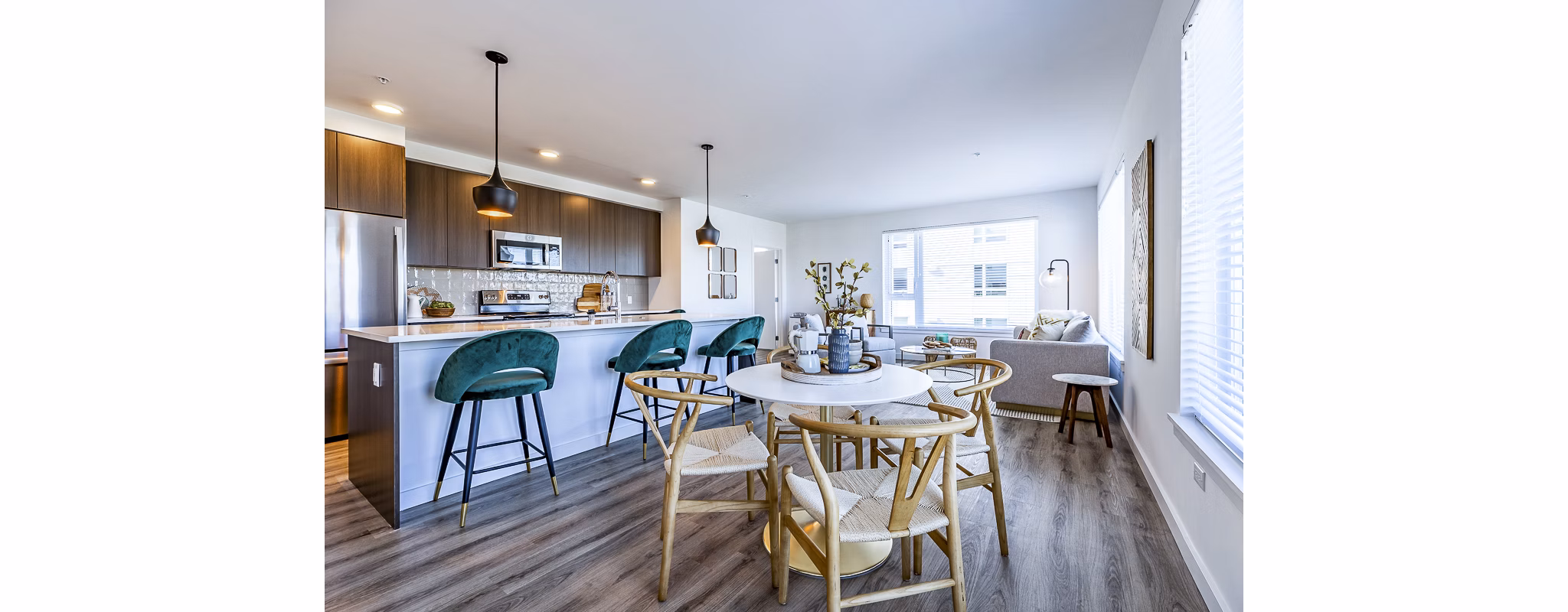 Dining room featuring modern chandelier and sleek dining set at Mason & Main Apartments