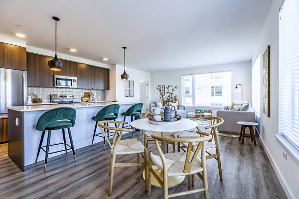 Dining room featuring modern chandelier and sleek dining set at Mason & Main Apartments