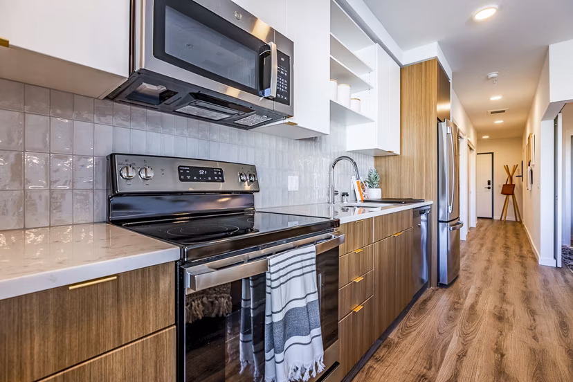 Modern kitchen with stainless steel appliances at Mason & Main Apartments