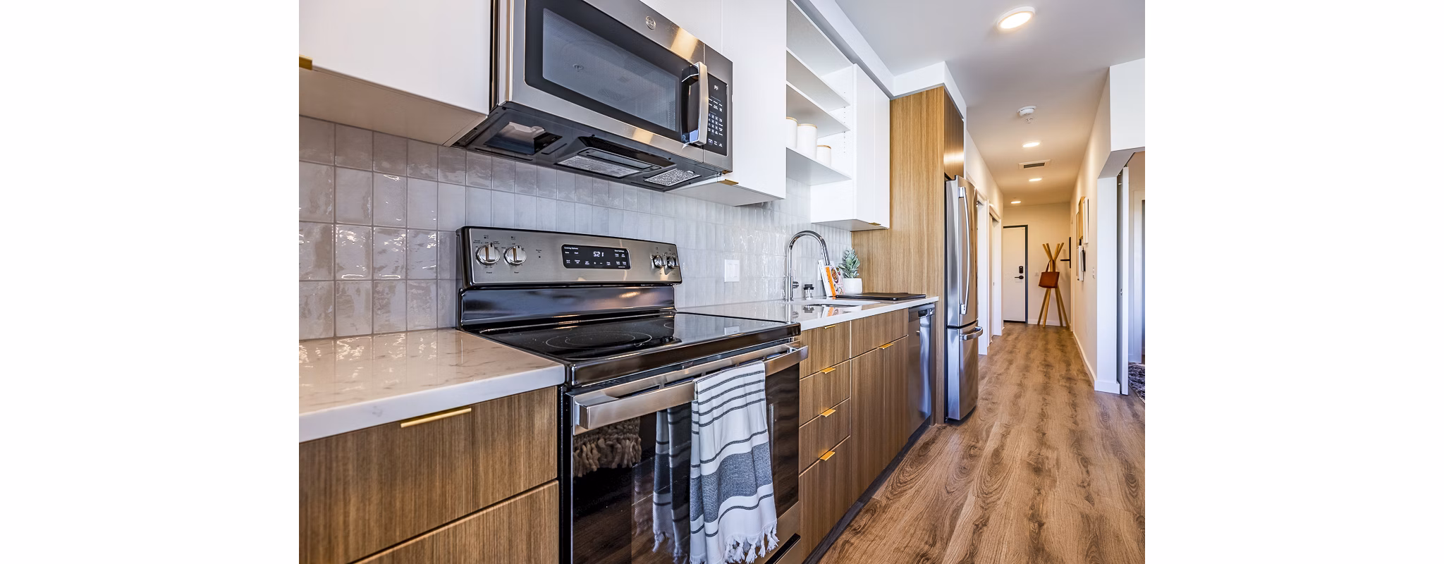Modern kitchen with stainless steel appliances at Mason & Main Apartments