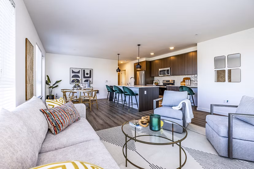 Spacious living room featuring modern decor and natural light at Mason & Main Apartments