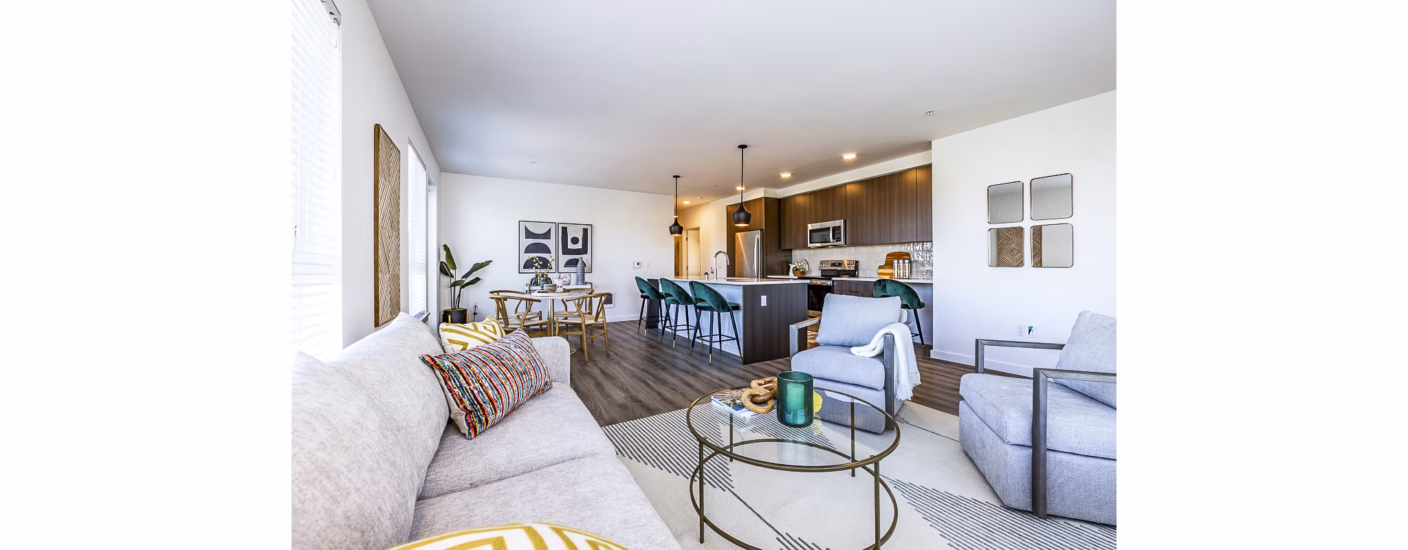 Spacious living room featuring modern decor and natural light at Mason & Main Apartments