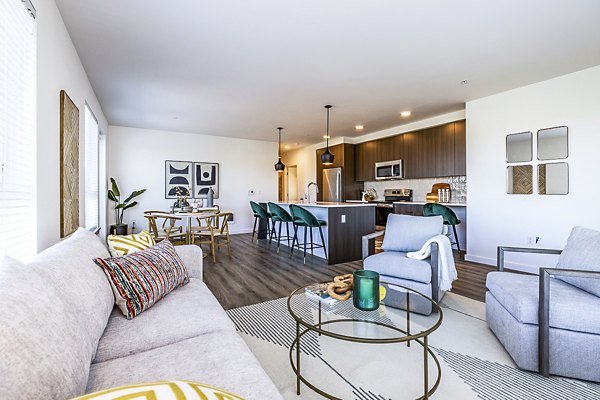 Spacious living room featuring modern decor and natural light at Mason & Main Apartments
