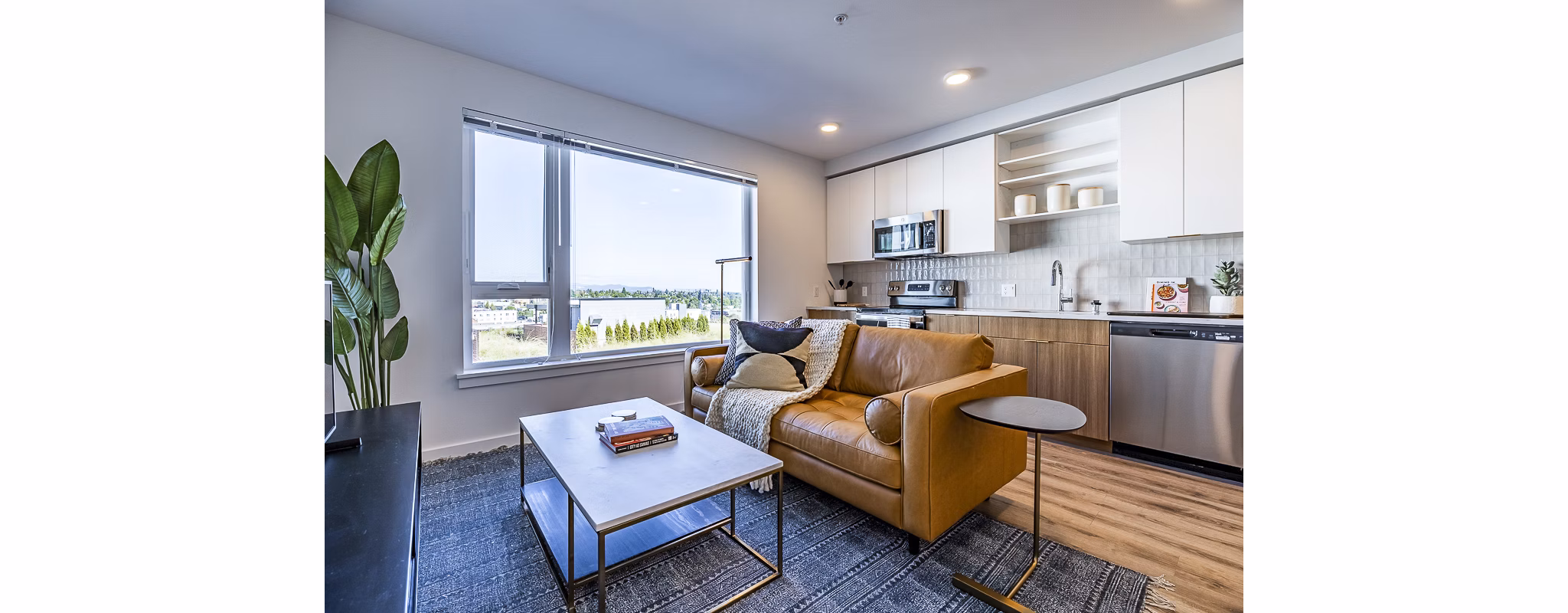 Spacious living room with chic modern decor in Mason & Main Apartments