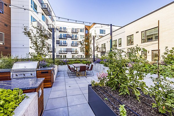 Outdoor grill area and patio at Mason & Main Apartments, ideal for social gatherings and leisure in a luxury setting