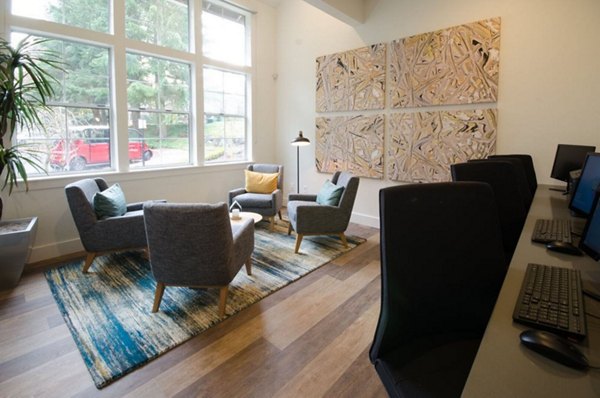 Stylish clubhouse featuring lounge seating and a fireplace at The Fairways Apartments