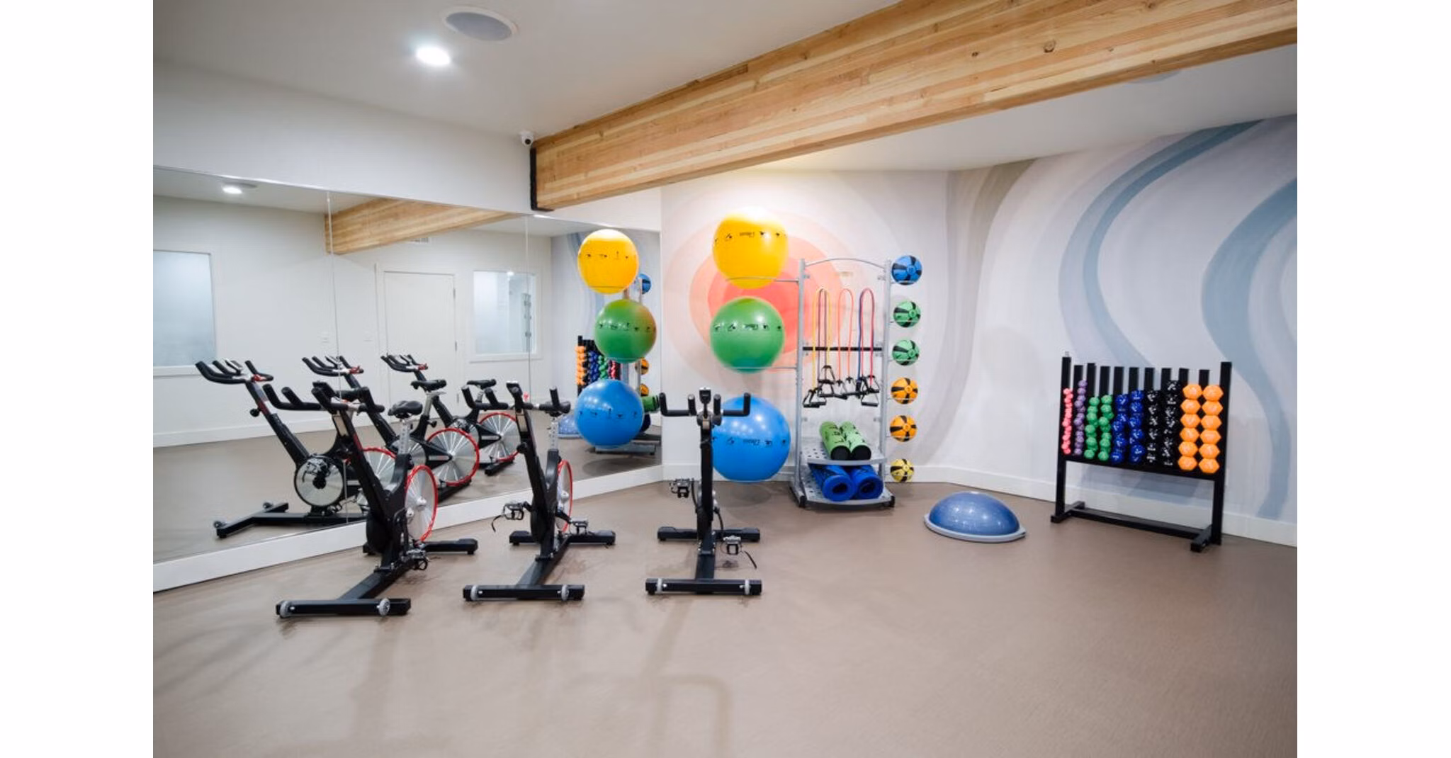 Yoga and spin studio with modern equipment at The Fairways Apartments