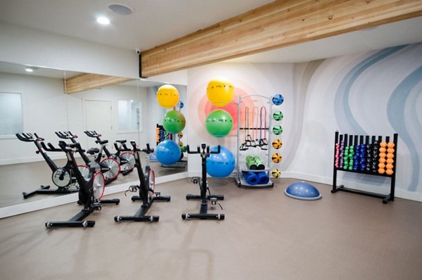 Yoga and spin studio with modern equipment at The Fairways Apartments