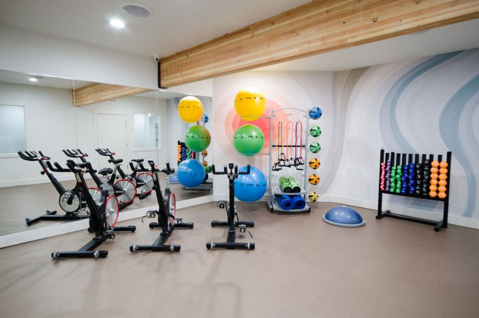 Yoga and spin studio with modern equipment at The Fairways Apartments