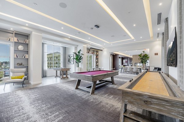 Game room with pool table and gaming consoles at The Core Natomas Apartments