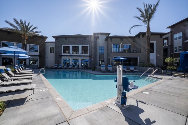 Outdoor pool with lounge chairs at The Core Natomas Apartments, offering luxury leisure for residents