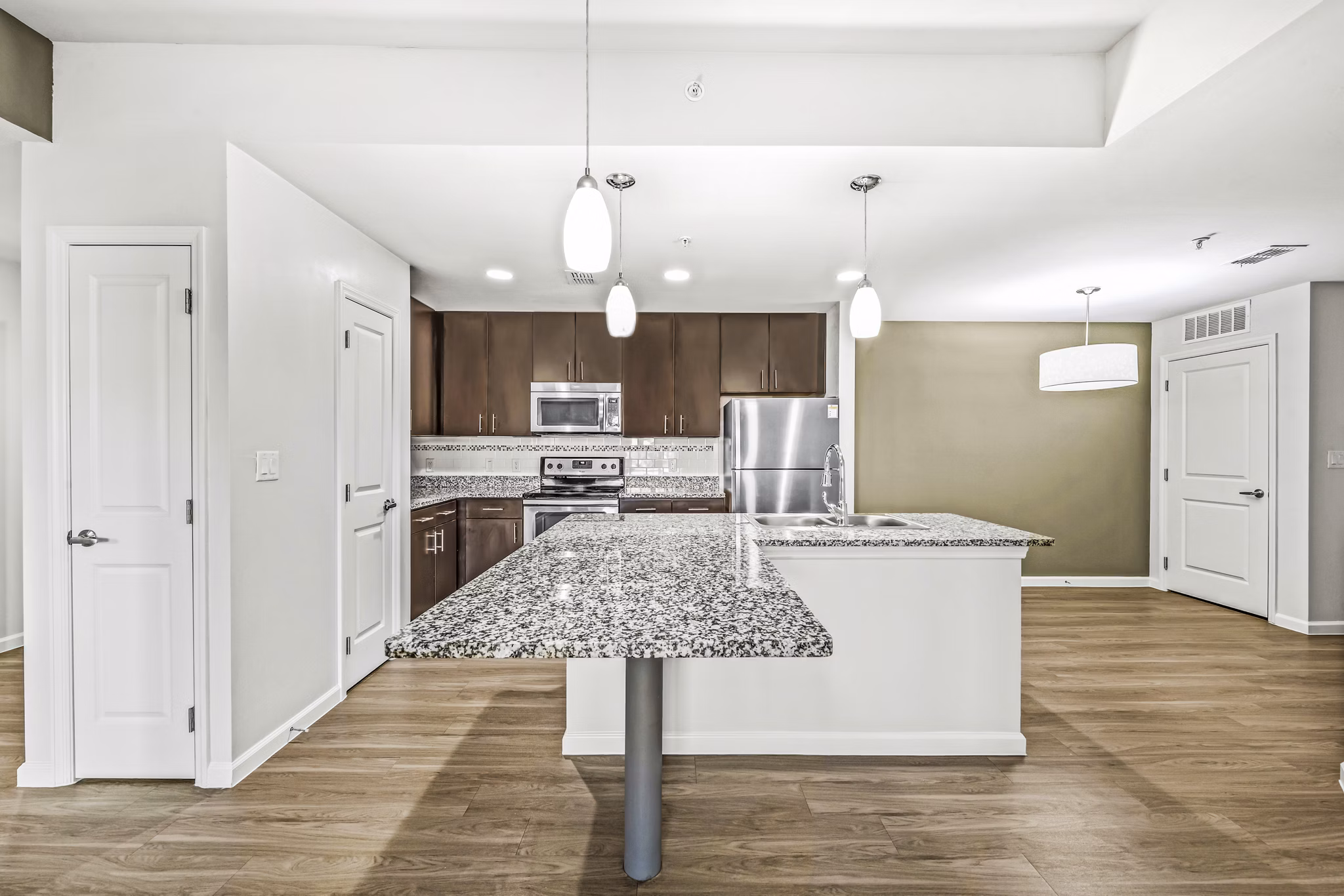 Modern kitchen with stainless steel appliances at Estero Oaks Apartments