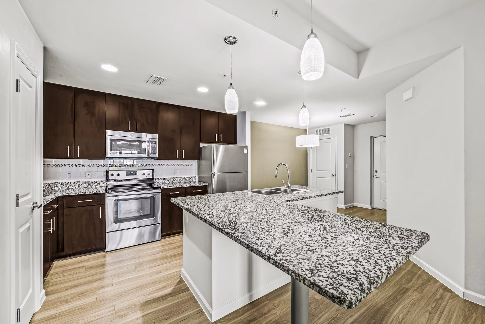 Modern kitchen with stainless steel appliances at Estero Oaks Apartments