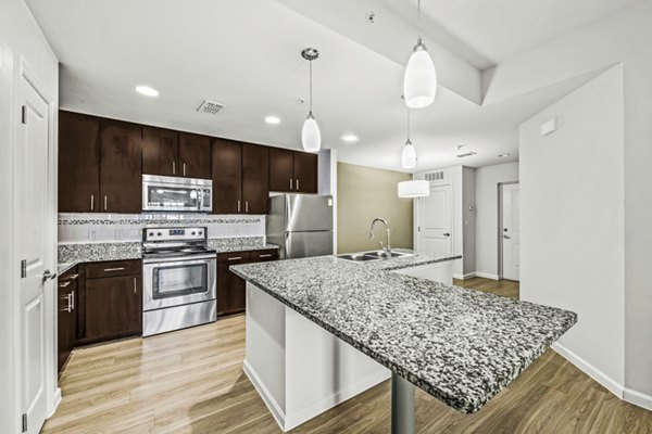 Modern kitchen with stainless steel appliances at Estero Oaks Apartments