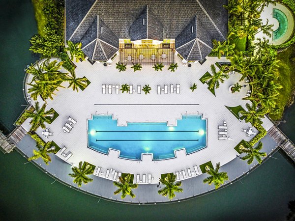 Resort-style pool with sun loungers at Estero Oaks Apartments