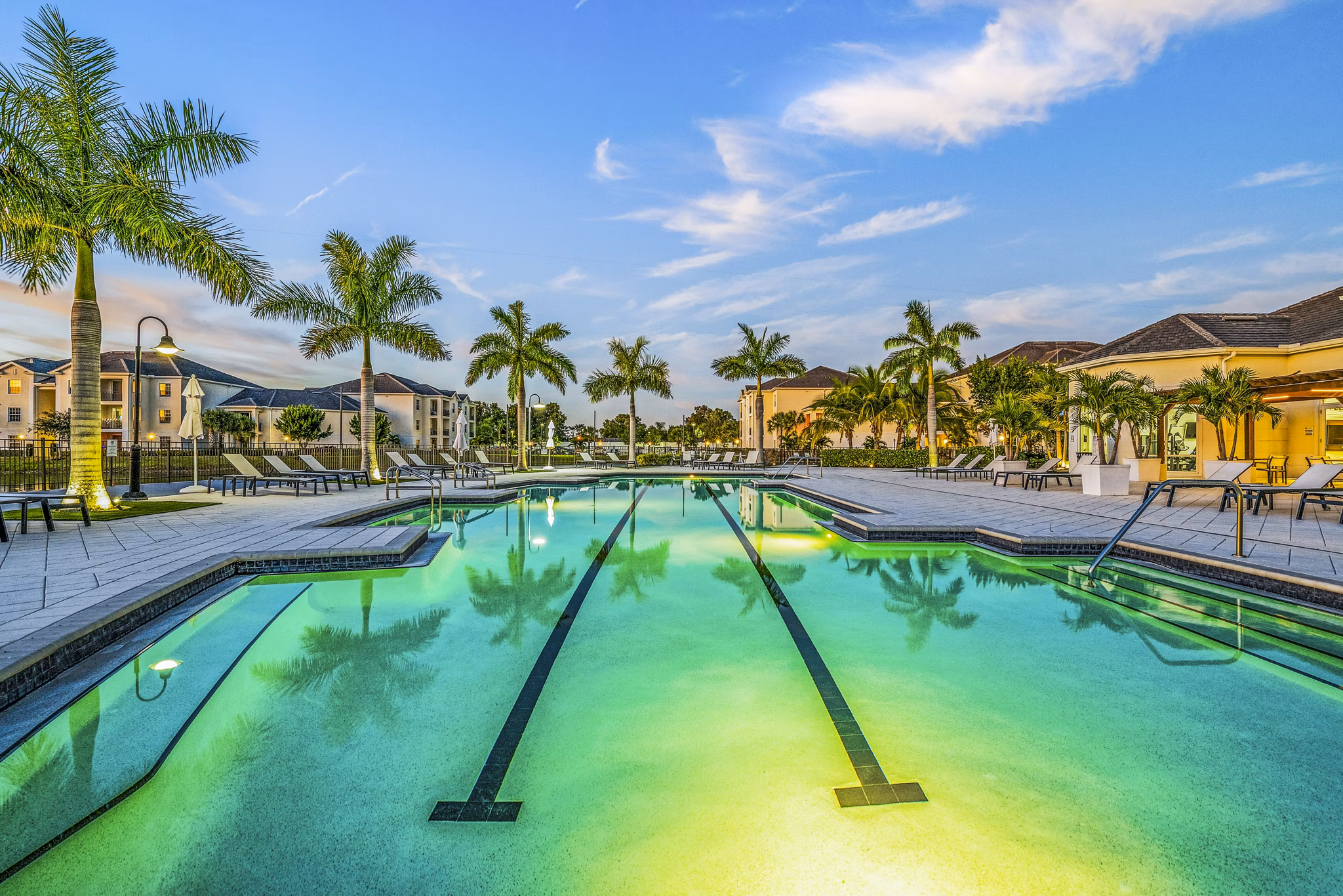 Modern pool with lounging areas at Estero Oaks Apartments, a luxury community offering premium relaxation and recreation amenities