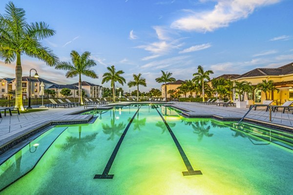 Modern pool with lounging areas at Estero Oaks Apartments, a luxury community offering premium relaxation and recreation amenities