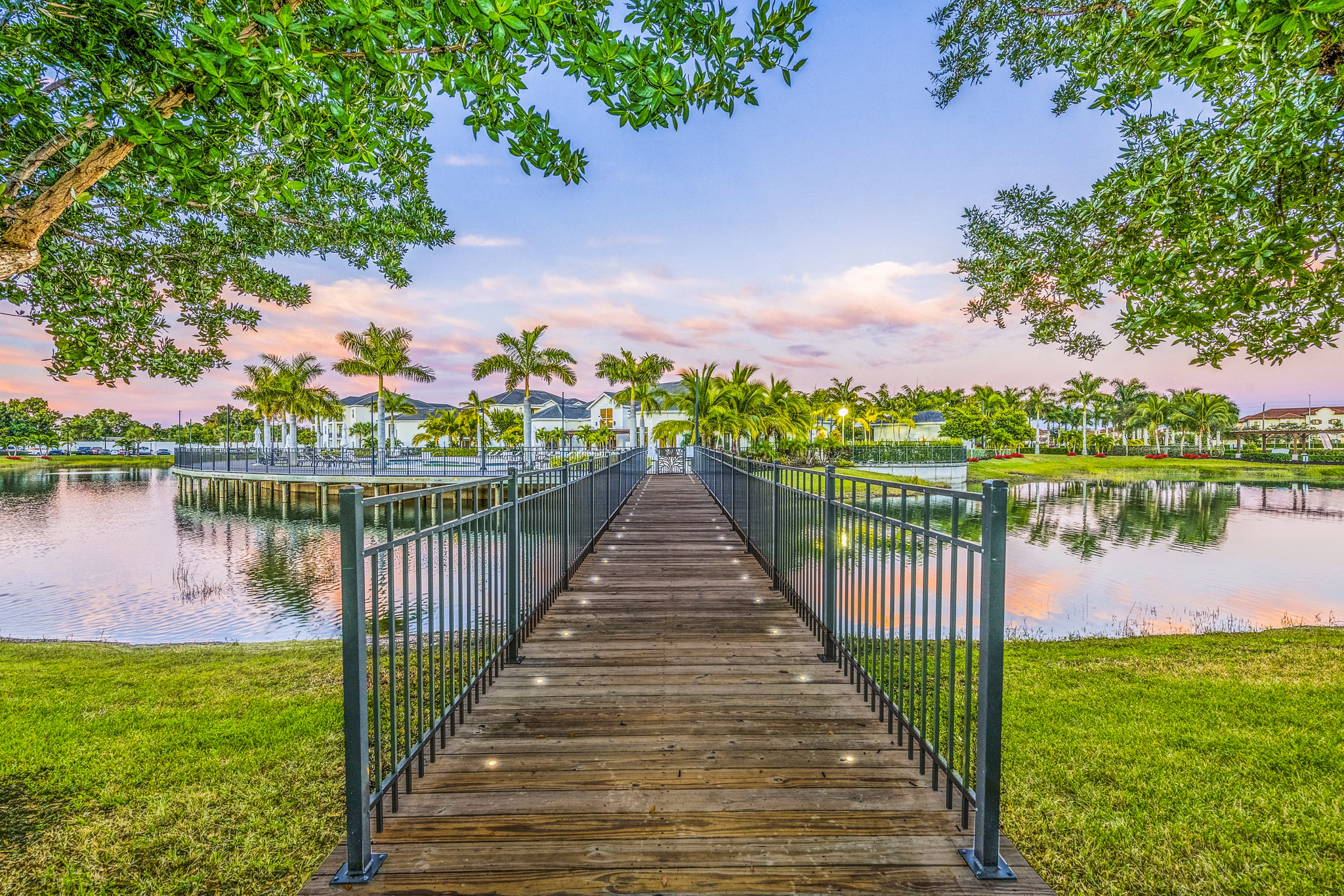 Estero Oaks: Serene view of luxury apartments surrounded by lush greenery in Estero