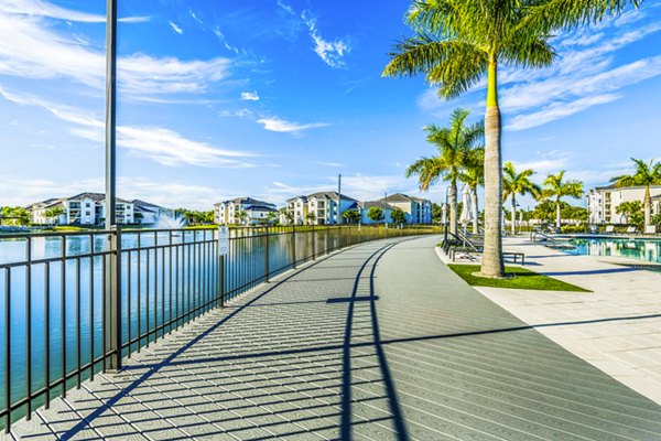 Estero Oaks Apartments: Luxurious outdoor pool view with lush landscaping in sunny Estero, perfect for relaxation and enjoyment