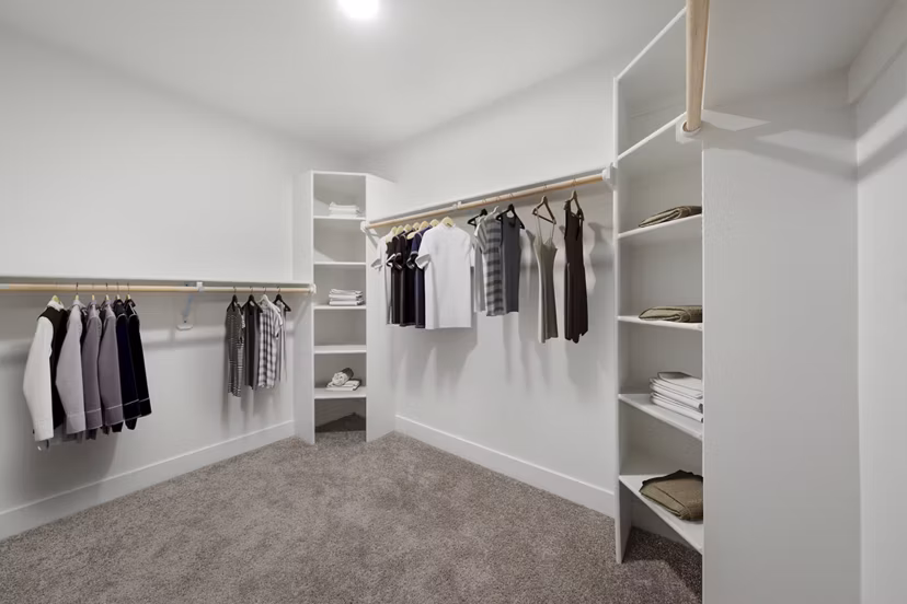 Walk-in closet with ample storage space at Album Marana Apartments