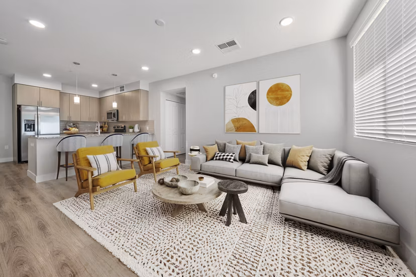 Spacious living room featuring cozy seating and large windows in Album Marana Apartments, luxury living near vibrant Tucson